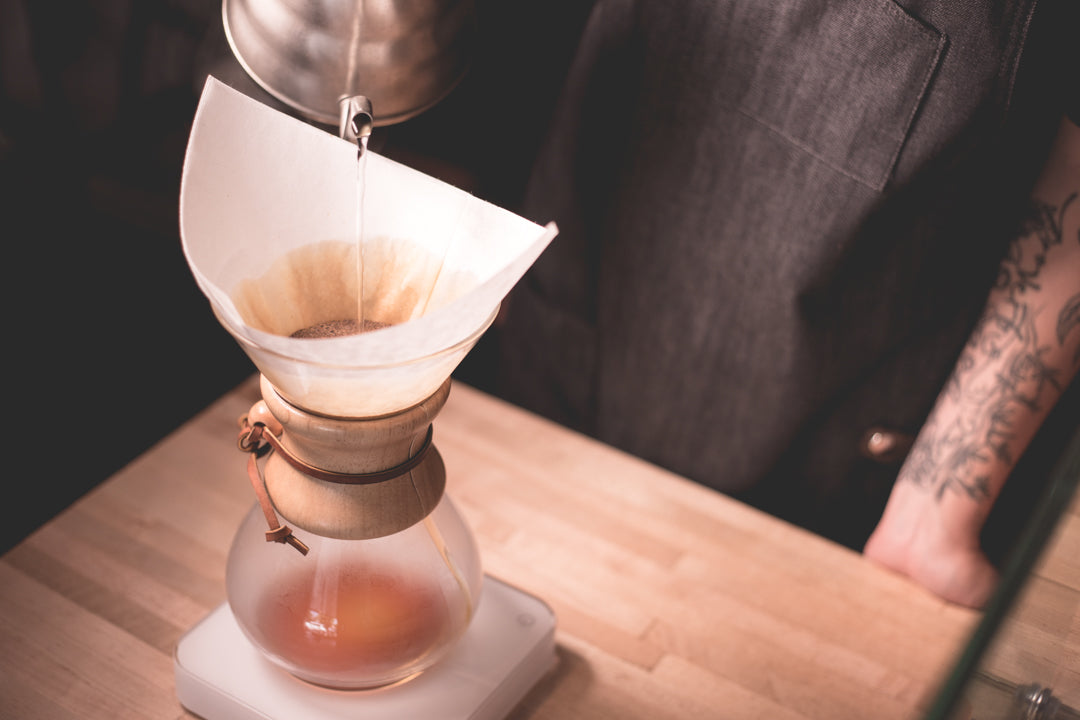 Coffee being precision brewed using the chemex pour over method